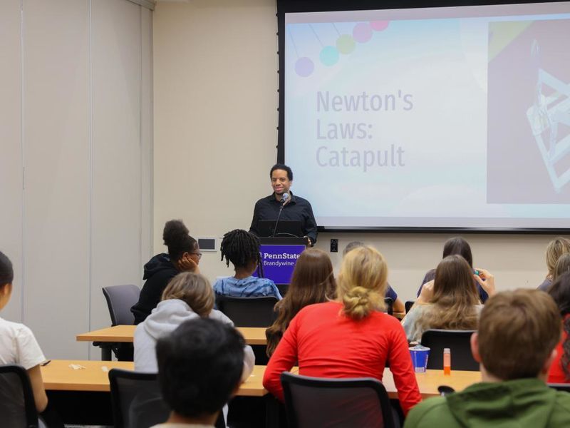 Man giving presentation on Newton's Law