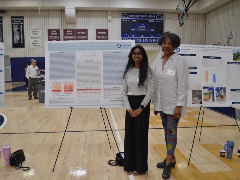 student and professor with poster