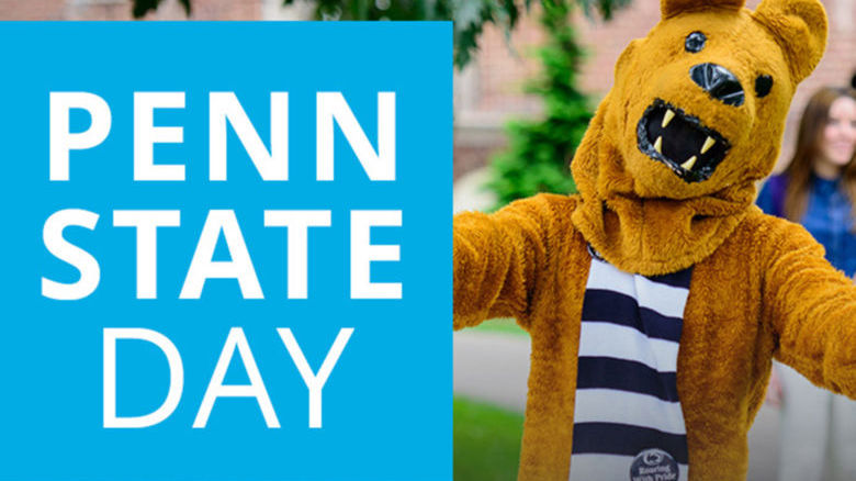 Lion mascot holding a sign that says Penn State Day