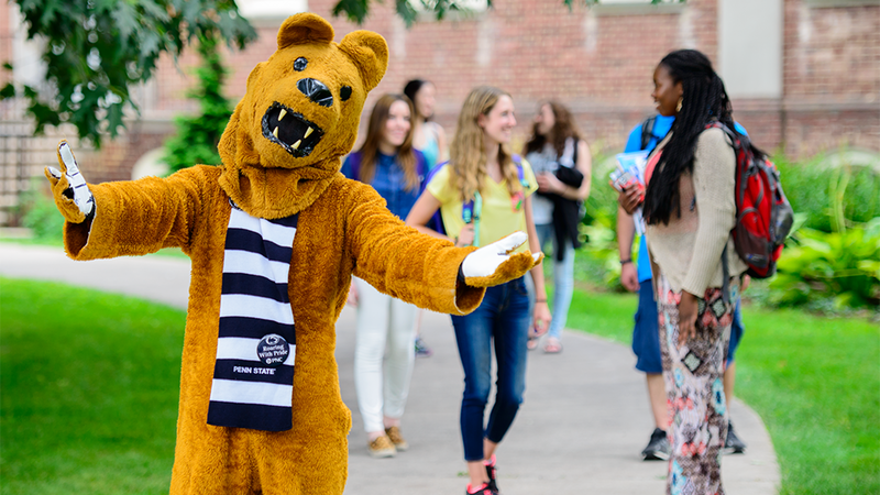 Nittany lion mascot welcoming students to campus.