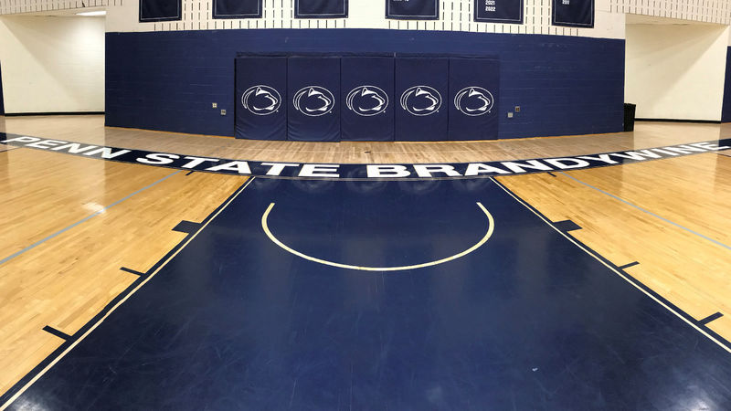 Penn State Brandywine gym floor showing Penn State athletics logos.