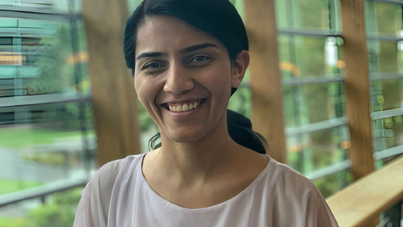 woman smiling with hair in a ponytail 