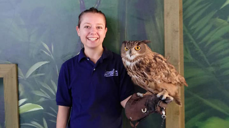 Penn State alumna Dana Piatt, who works as an animal trainer, holding an owl.