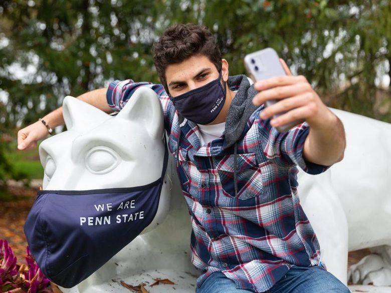 Student taking a selfie with Brandywine lion shrine