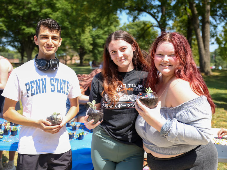 students holding terrariums outdoors