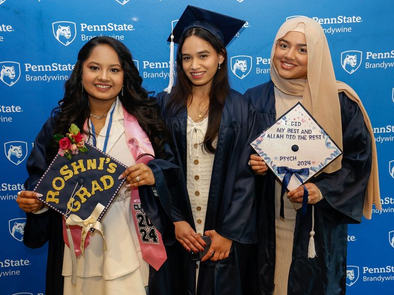 three students at graduation