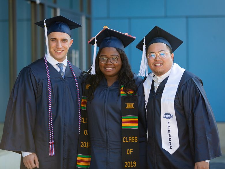 Students smiling after graduation.