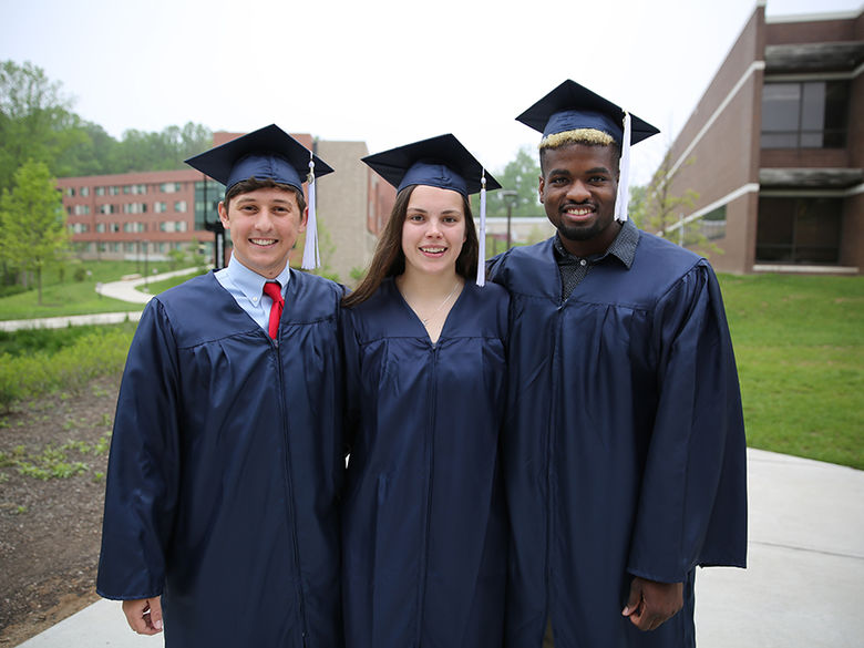 Students smiling after graduation ceremony.