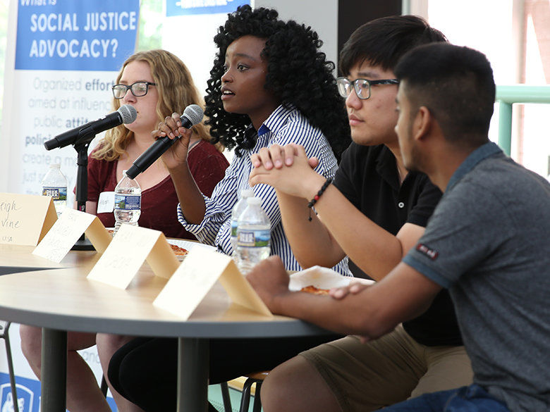 Students speaking on a panel