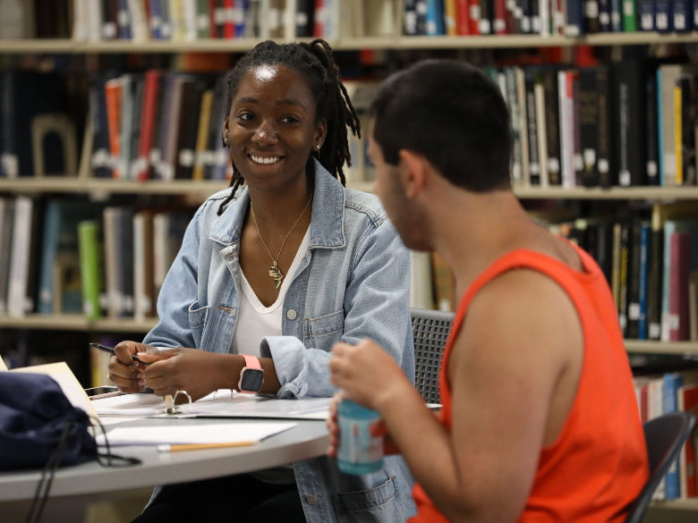 Peer tutor working with student at table