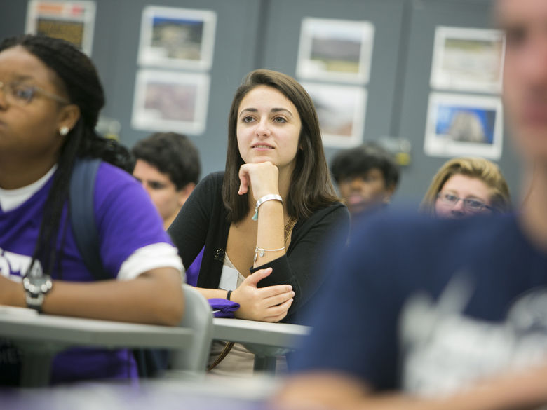 student in class listening to professor