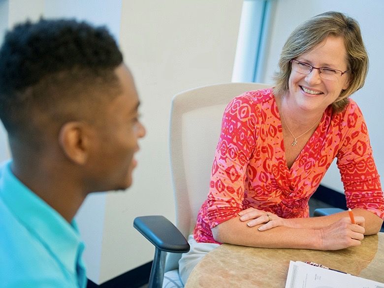 Male student with female career adviser