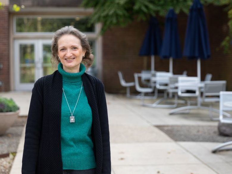 Adult student Neesa Fahy smiling in front of the Main Building.