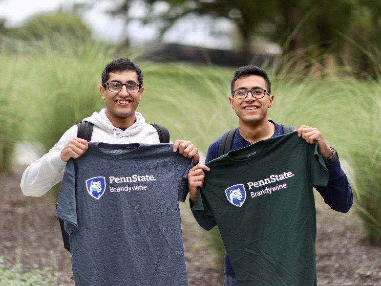 Male students posing with new Brandywine t-shirts