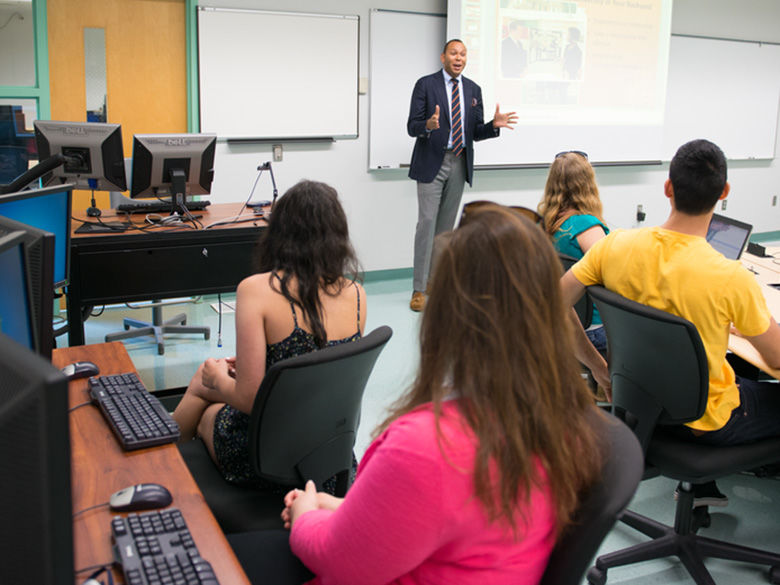 Students in classroom being instructed by professor