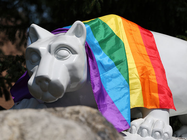 lion with colored flag draped over it