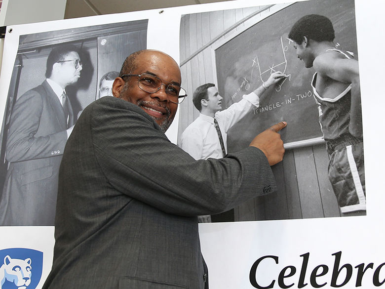 An alum pointing to his picture from when he was a student on the basketball team