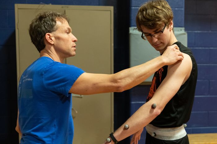 Penn State Brandywine's Tim Niiler attaching retroreflective markers  to a research participant.