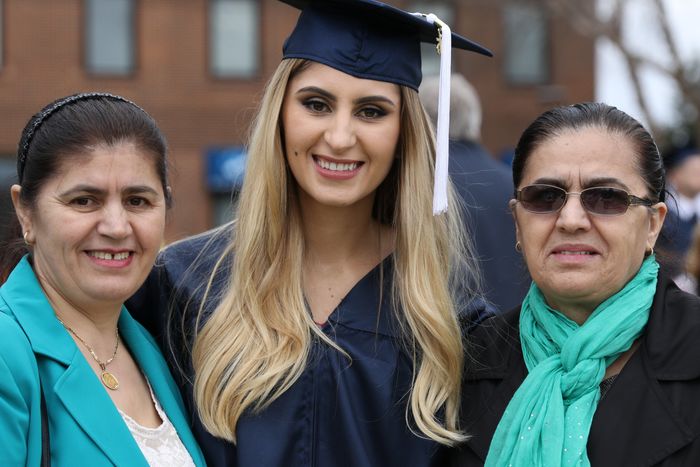 Student stands with family