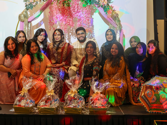 group of students at mock south asian wedding wearing traditional south asian attire