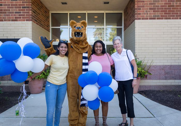 Chancellor Kristin Woolever congratulates Myeisha Matos and Donna Aggie