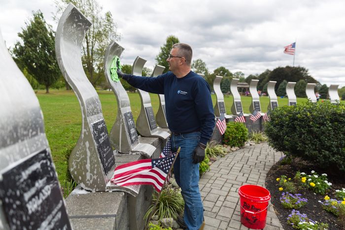 Bill Tyson cleans the Delaware County Law Enforcement Memorial