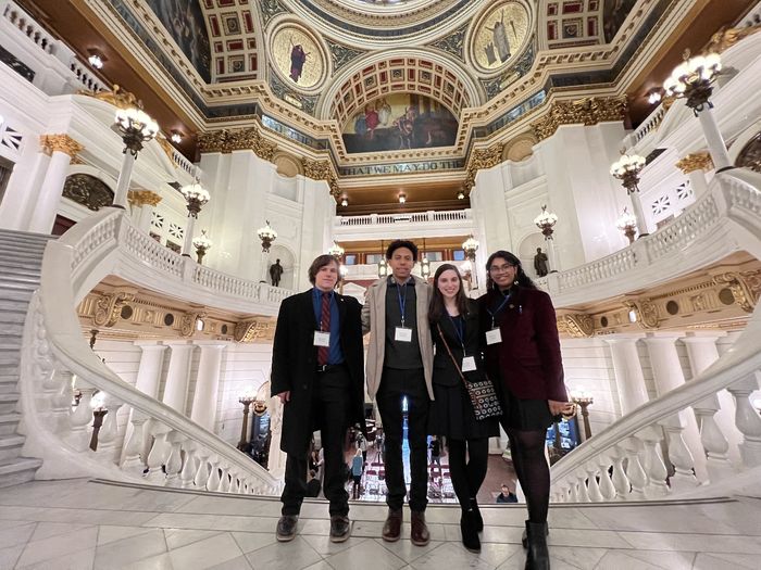 Four students stand in the rotunda of the Pennsylvania Capitol.