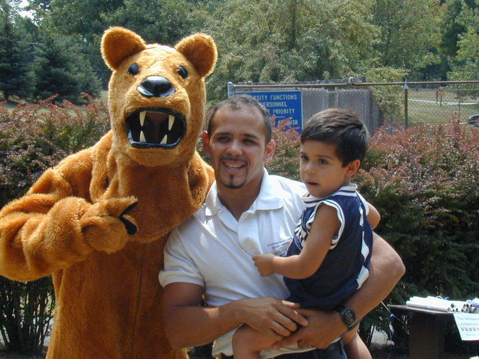 A father and son stand beside the Penn State Nittany Lion