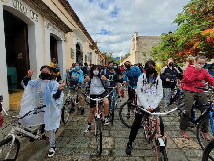 Students riding bicycles through Oaxaca