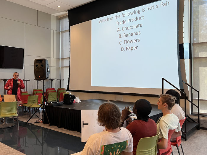 Students look at a screen showing a trivia contest.