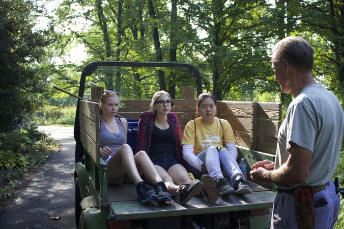 Students sit in vehicle while listening to directions