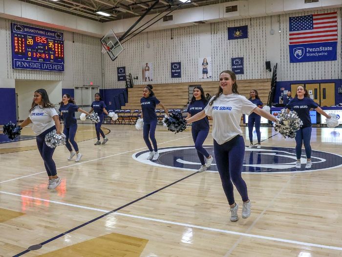 Dancers on the Hype Squad perform on the gym floor during a home basketball game.