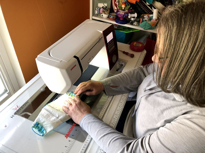 Laura Molen, Brandywine adjunct instructor, making a mask. 