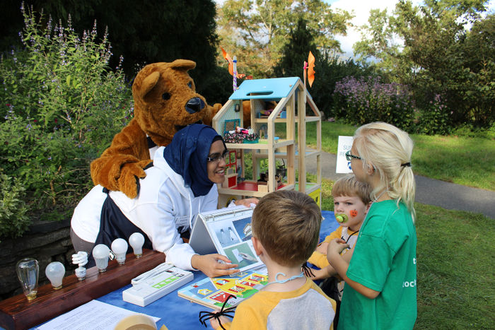 Student and Lion mascot teaching children.