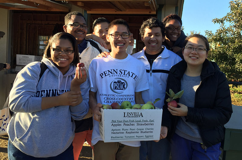 7 students with box of apples