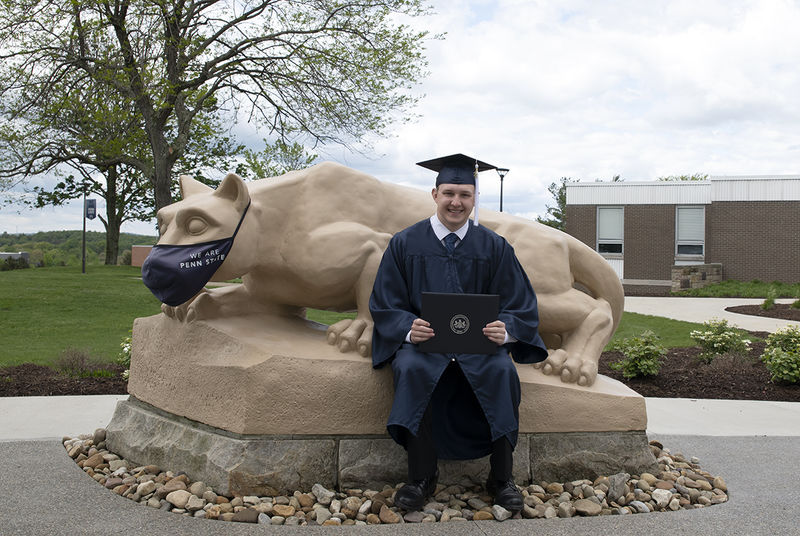 Bailey Stapleton sitting with the Lion Shrine.