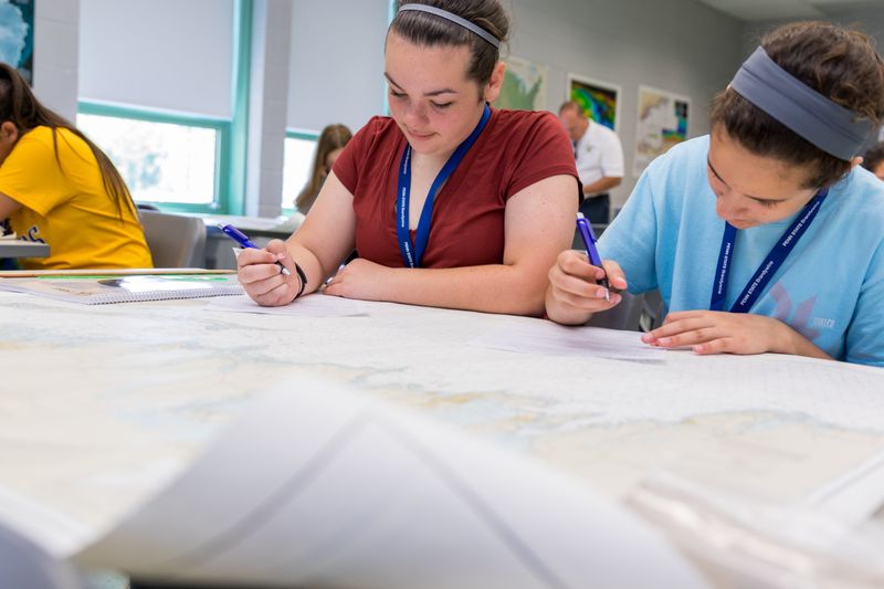 Girls working with nautical charts
