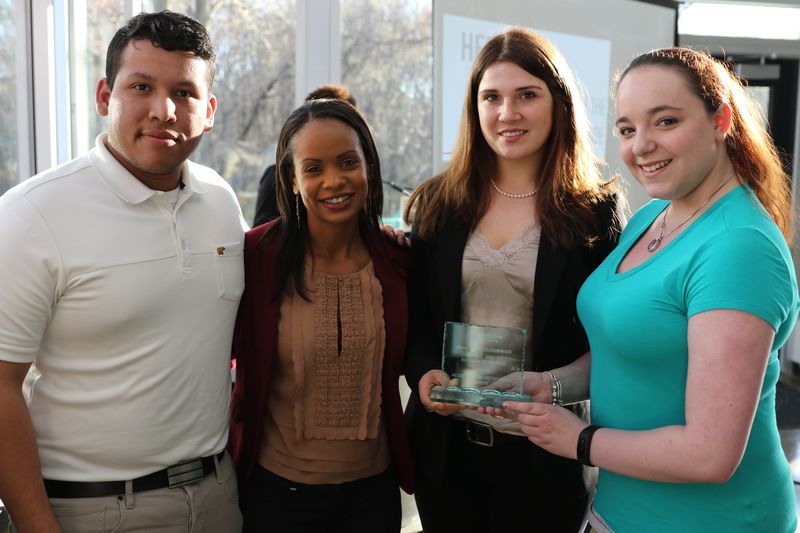 Students stand with Stephanie Jones witht their award.