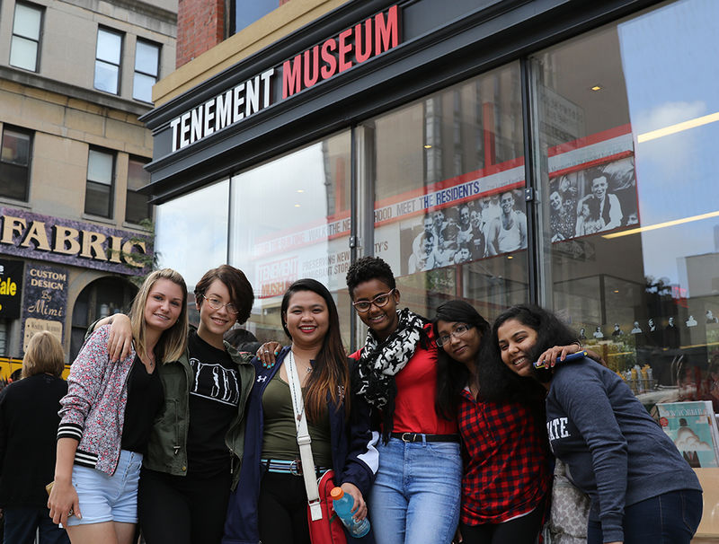 students in front of Tenement Museum sign