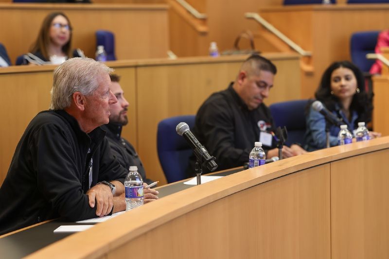 people sitting at table in auditorium