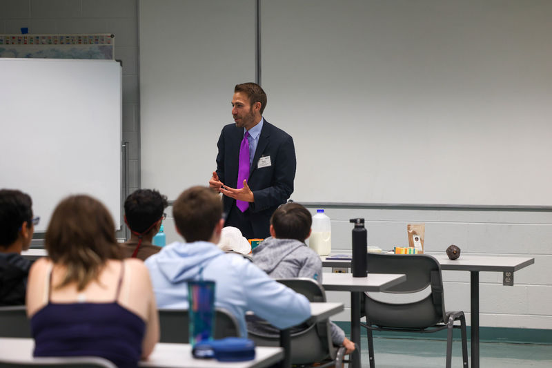 Drew Anderson speaking with students