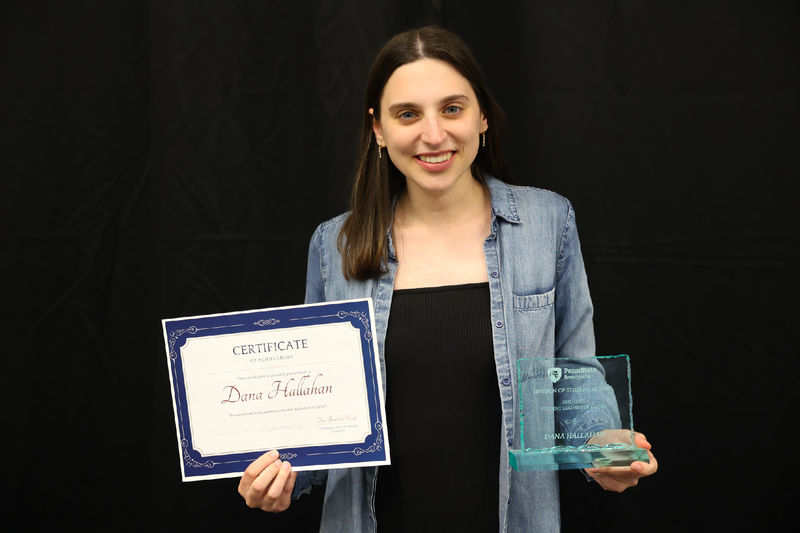 Woman holding award and certificate