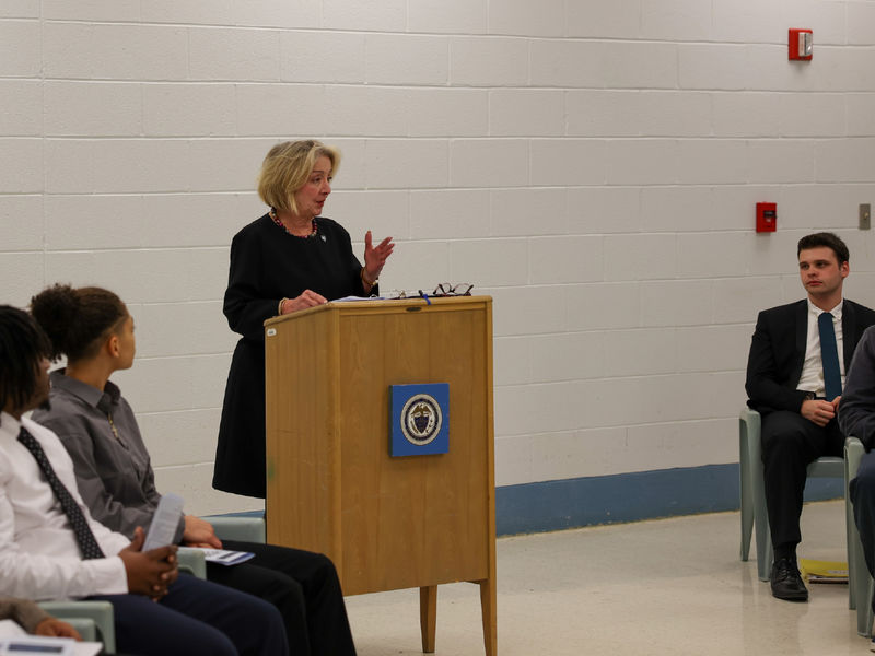 Marilyn Wells talking at a podium