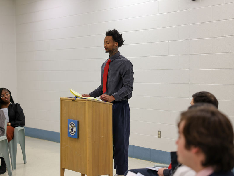 Dymir standing at a podium