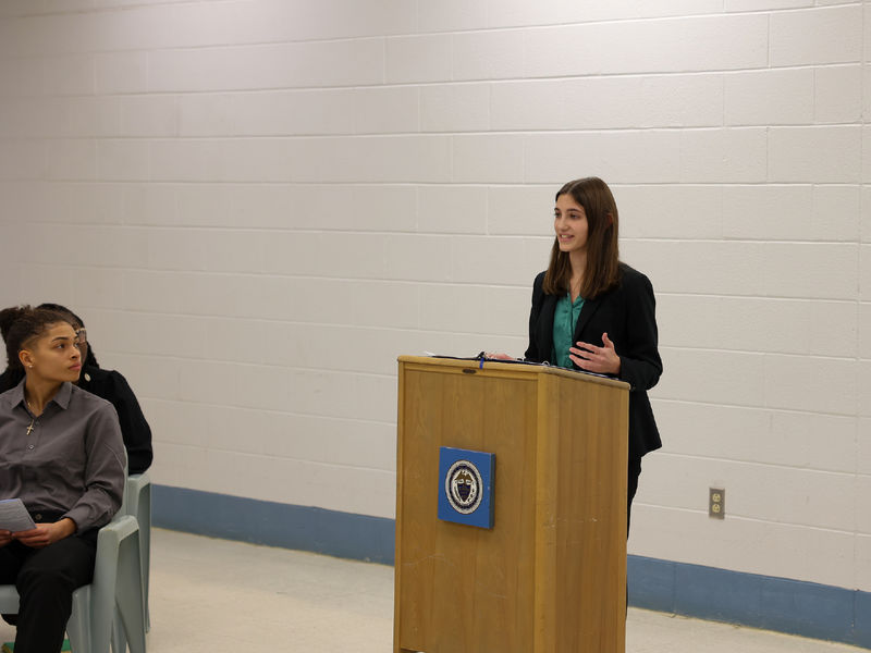 Aerin Yoder standing at a podium