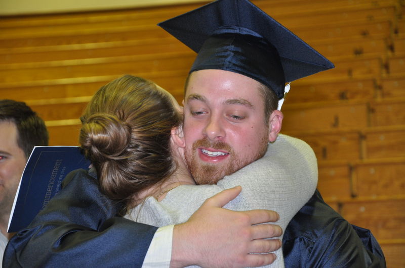 graduate hugging woman