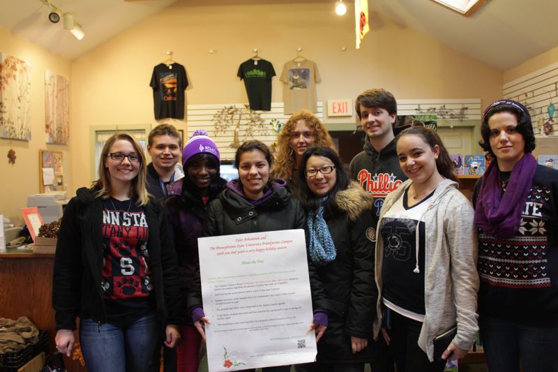 Students stand with sign explaing the project