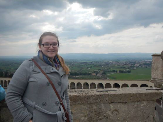 Megan Griffith standing in front of a bridge in Italy