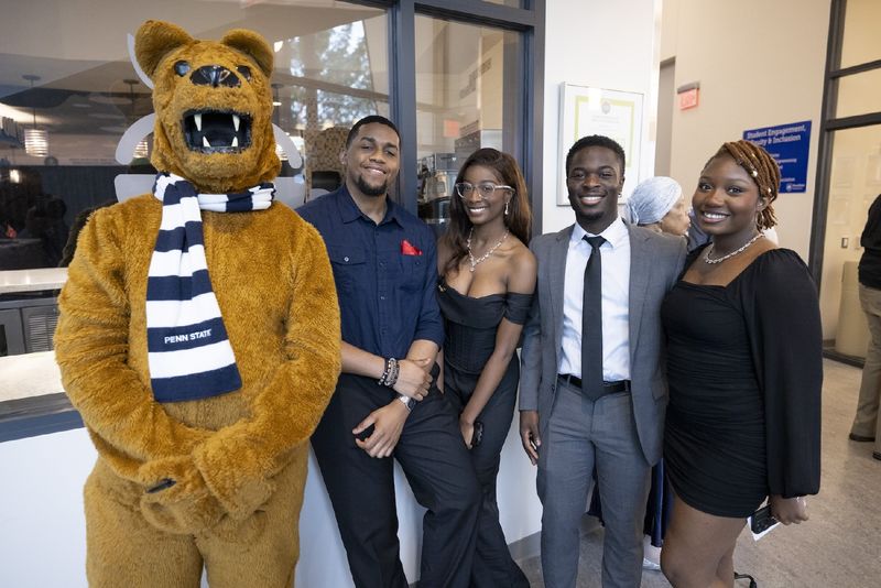 students standing with Nittany Lion