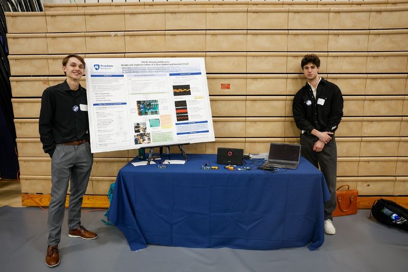 students presenting work on poster